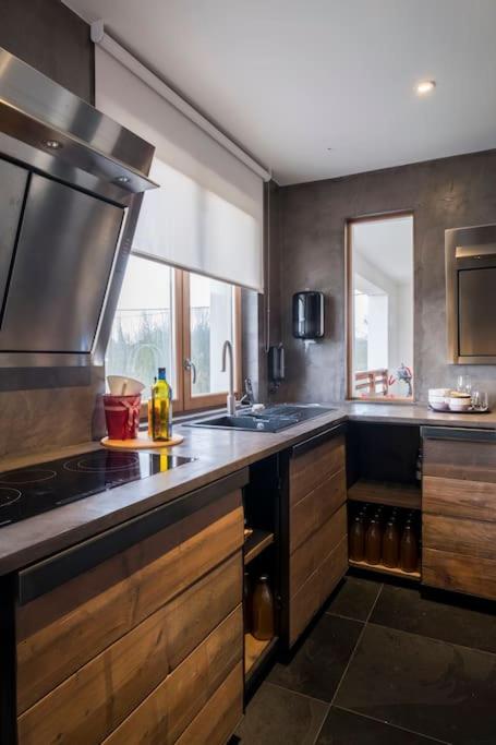 a kitchen with a sink and a stove top oven at Familie &amp; Vriendenwoning met fantastisch uitzicht in Ellezelles