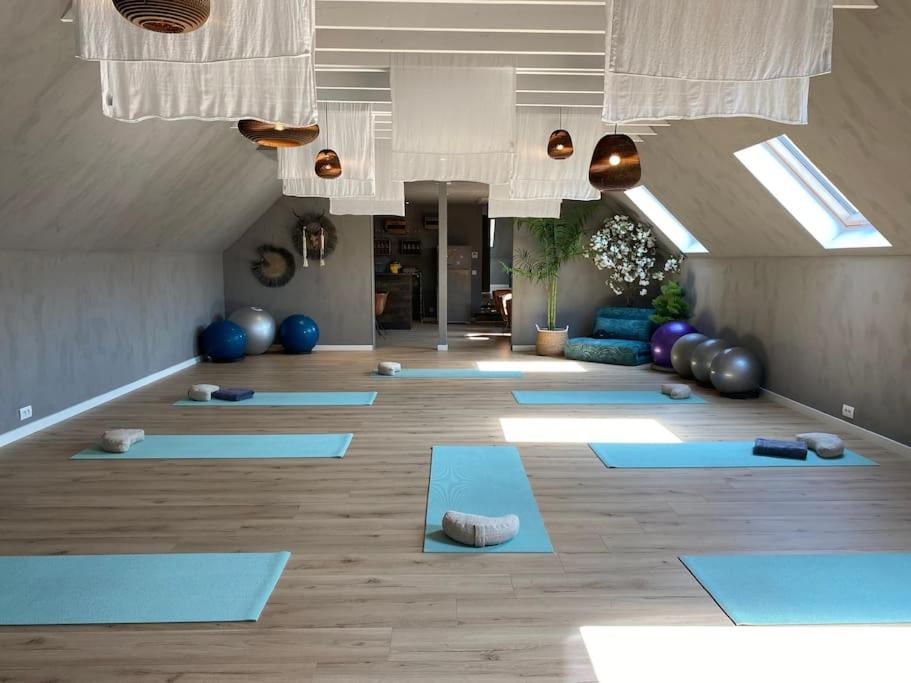 a yoga room with blue mats on the floor at Familie &amp; Vriendenwoning met fantastisch uitzicht in Ellezelles
