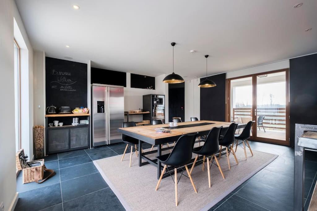 a kitchen with a large wooden table and chairs at Familie &amp; Vriendenwoning met fantastisch uitzicht in Ellezelles