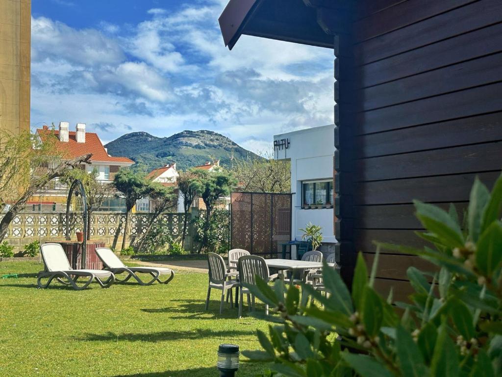 a yard with chairs and tables and a mountain at Chalet Pitu - 17801 in Piedrahita
