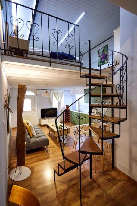 a living room with a spiral staircase in a house at The Wine House in Chios