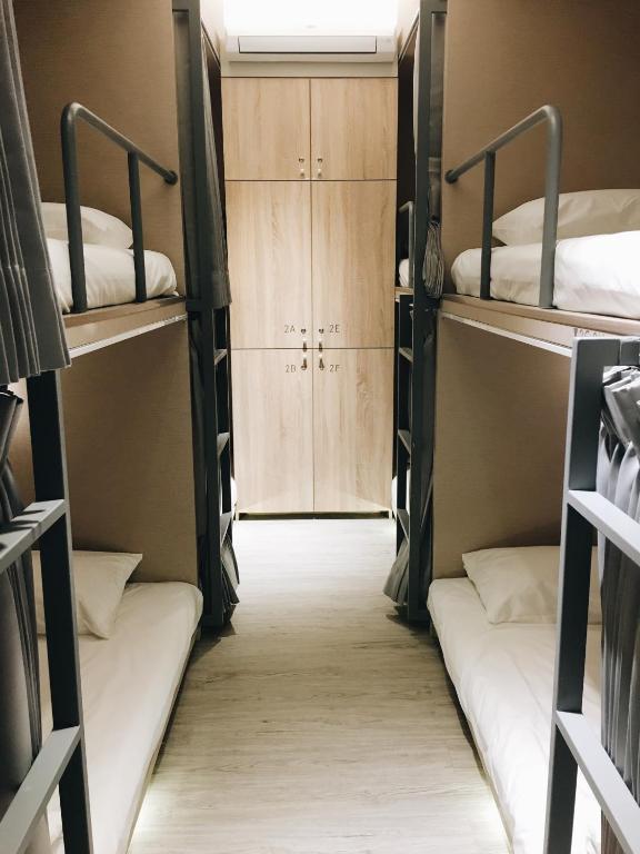 Postel nebo postele na pokoji v ubytování 日初青旅 Sundaily Hostel 北車