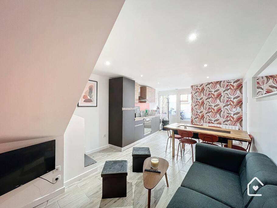 a living room with a blue couch and a kitchen at Bienvenue chez Janna - 6 Personnes - Parking facile in Châtellerault