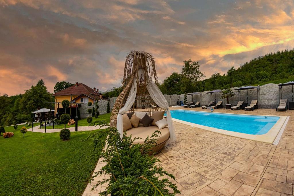 a slide in a yard next to a swimming pool at VALEA MAGURII in Novaci-Străini