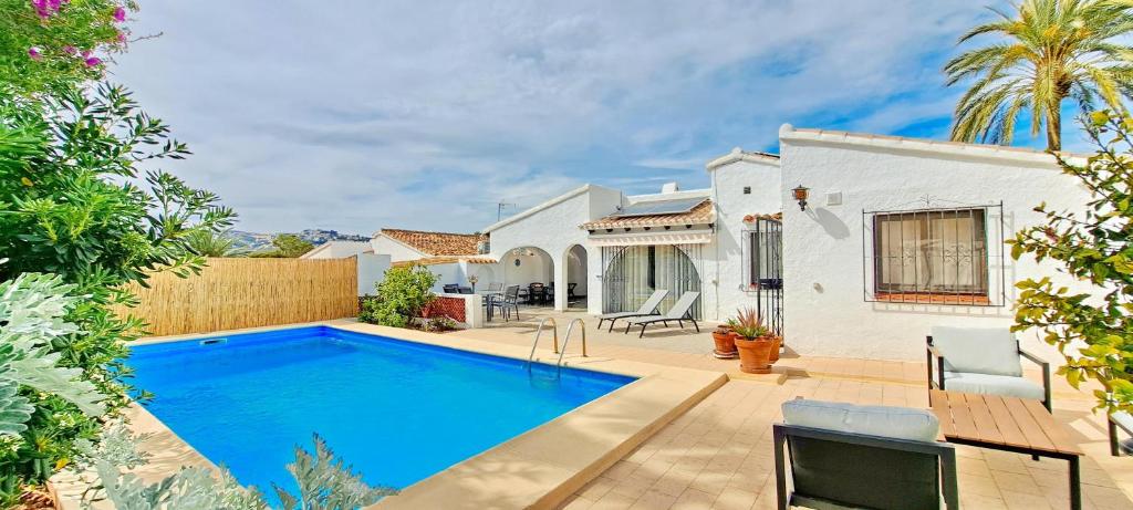 a villa with a swimming pool and a house at Villa Sol in Moraira