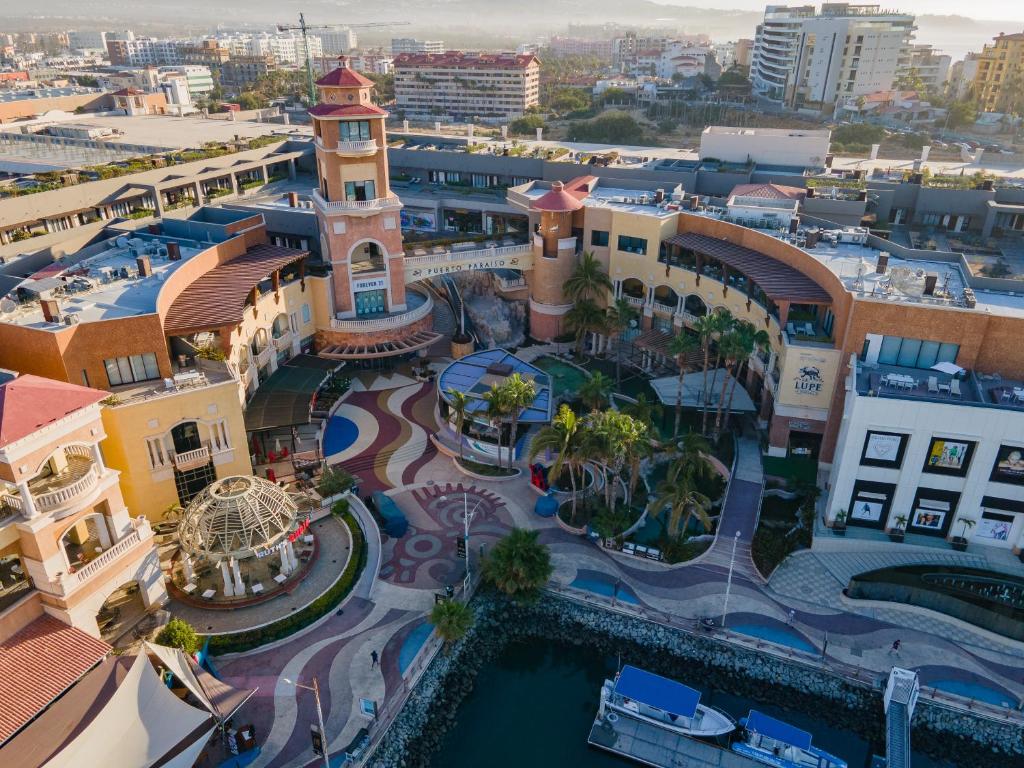 an aerial view of a city with buildings at The Paraiso Residences at Marina Cabo in Cabo San Lucas
