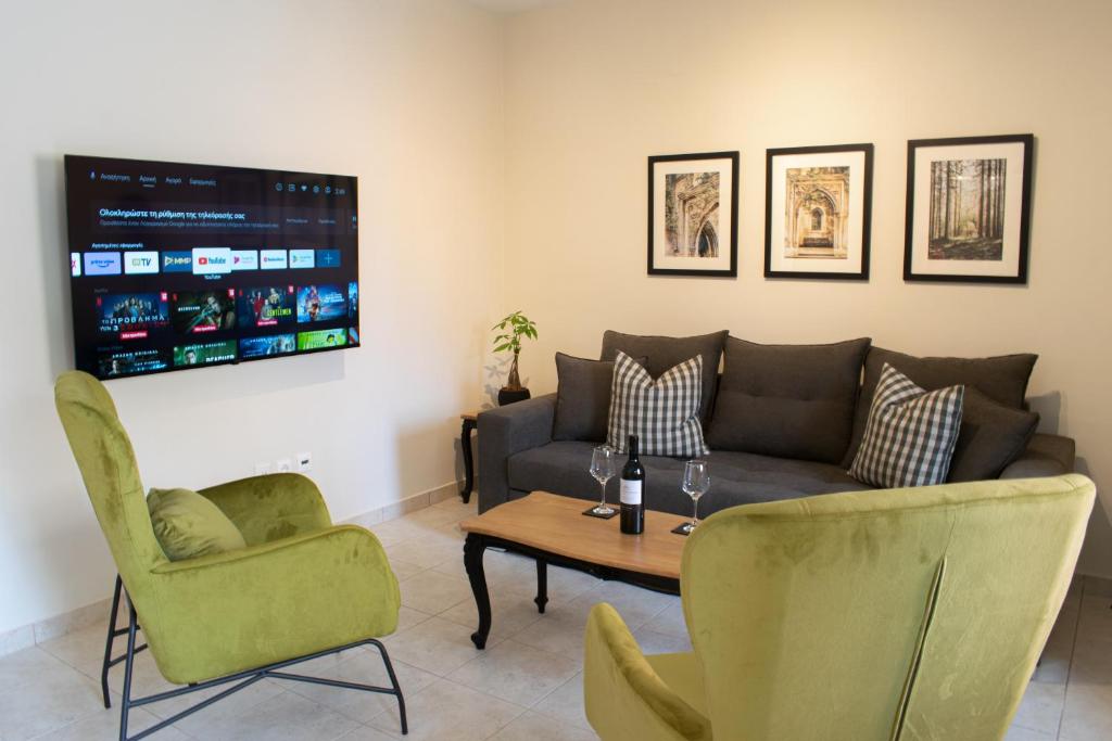a living room with a couch and a table and chairs at Alba Spacious Maisonette in Corfu