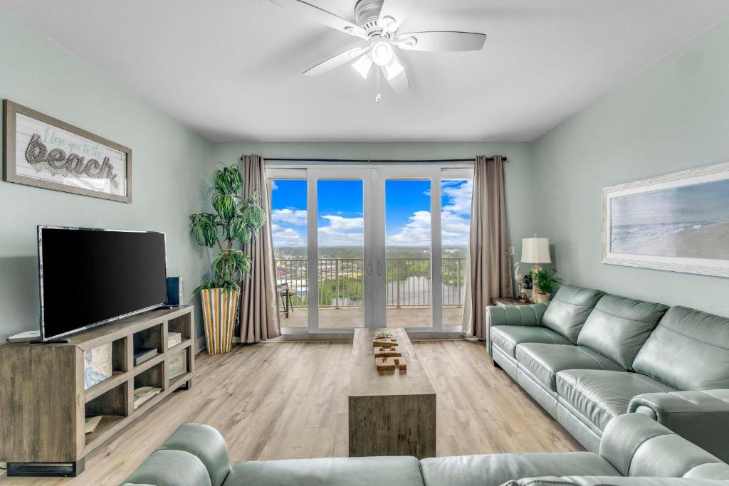 a living room with a couch and a flat screen tv at Laketown Wharf 1331 in Panama City Beach