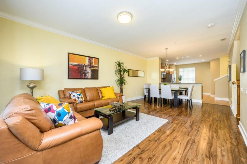 a living room with a couch and a table at New Modern Townhome, Near The Parks - 4030 in Orlando