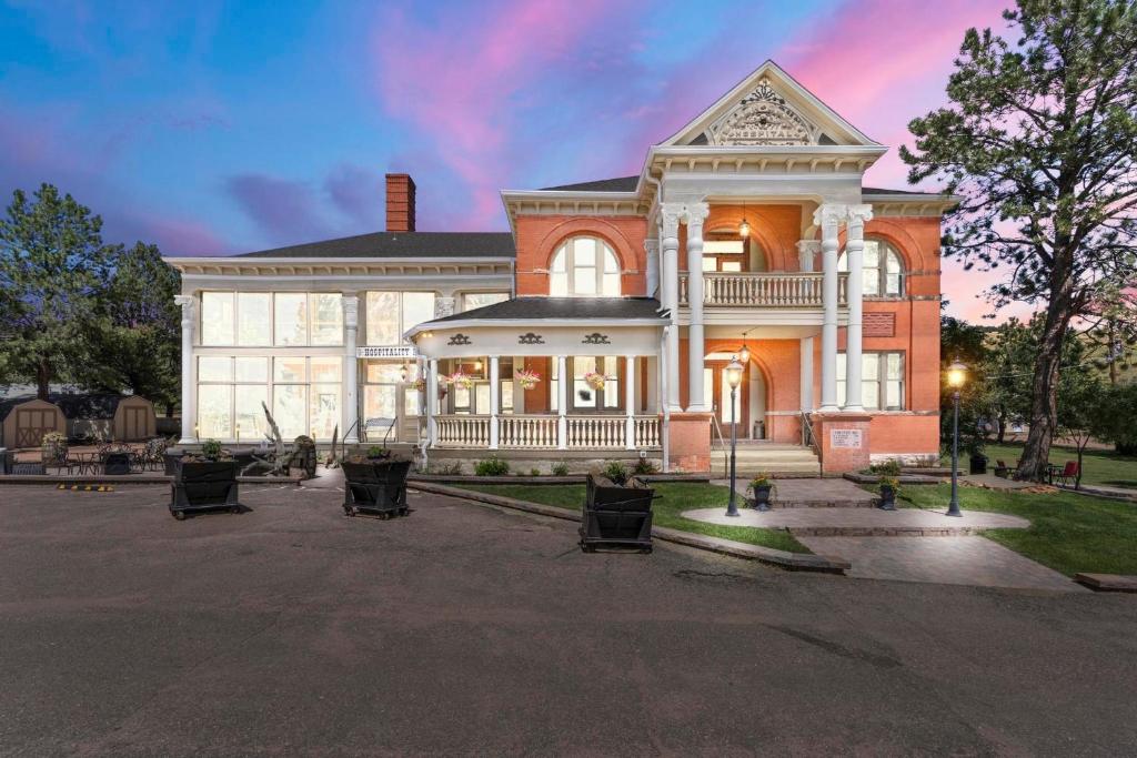 a large brick house with a white turret at Cripple Creek Hospitality House in Cripple Creek