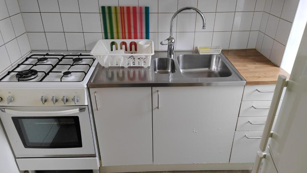 a small kitchen with a sink and a stove at Full Apartment in Malmö