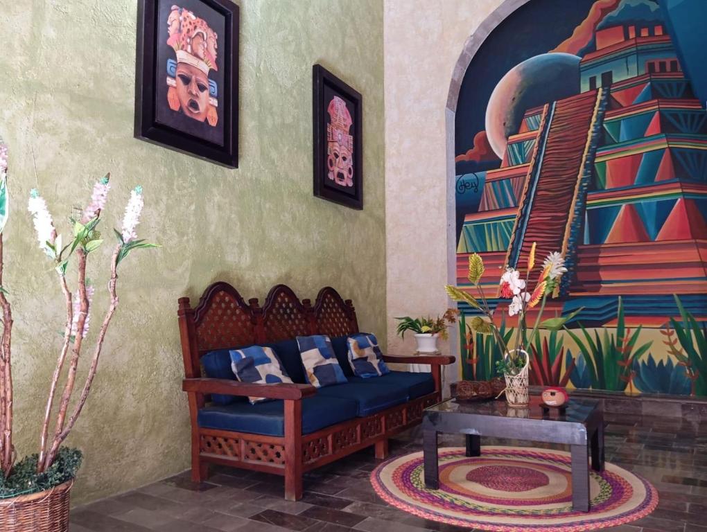 a living room with a couch and a mural at Residencial Edzna in Campeche