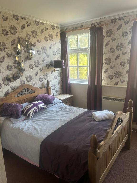 1 dormitorio con cama y ventana en Tayleur arms, en Crudgington