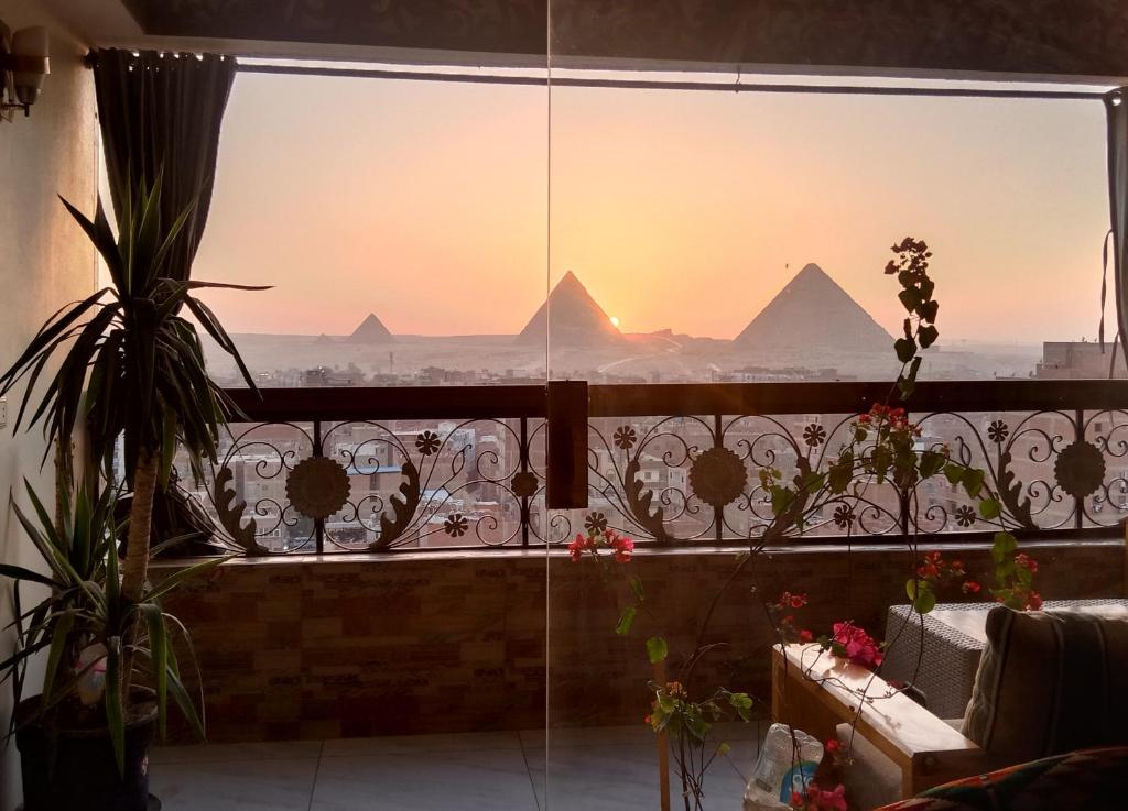 a view of the pyramids from a window in a room at Giza Pyramids View Guest house in Cairo