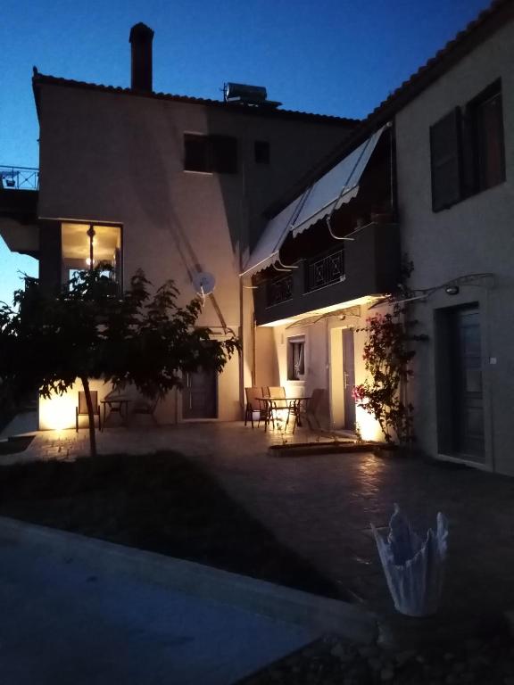 a night view of a building with a patio at La casa di Elen4 in Platy