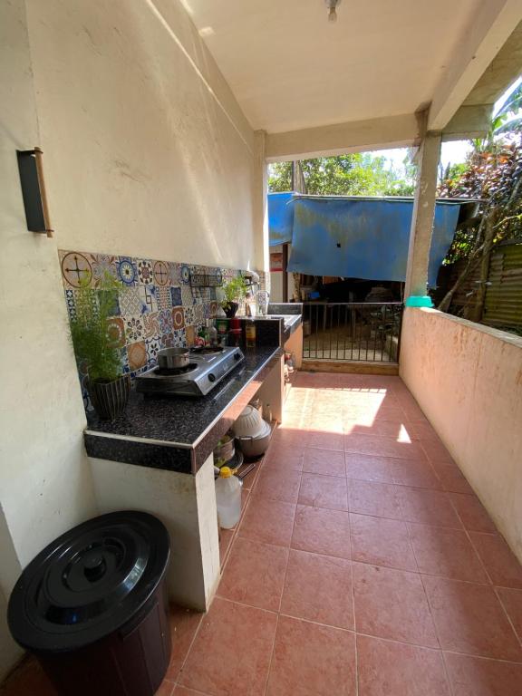 an outdoor kitchen with a counter and a sink at Room near tagaytay • wifii/Netflix in Tagaytay