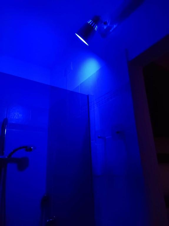 a bathroom with a blue light in a room at Nella dolce Grotta in Monsummano Terme