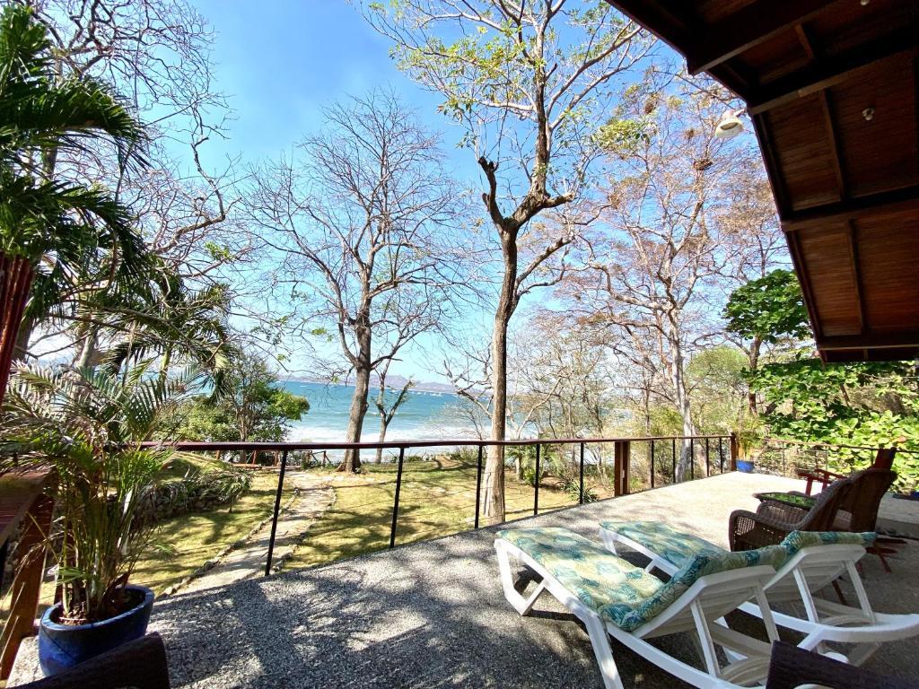 a porch with chairs and a view of the water at Casa Corona Del Mar - 4 Bdr - Beachfront in Tamarindo