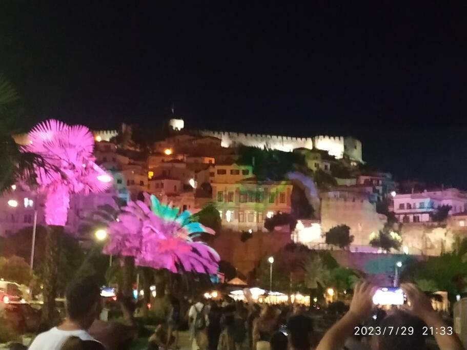 a crowd of people standing in front of a city at night at Kavala,Garden House in Kokkinókhoma