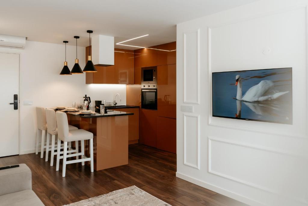 a kitchen with a white door and a kitchen with a table at A 0.4 - Alexa Smart House in Braga