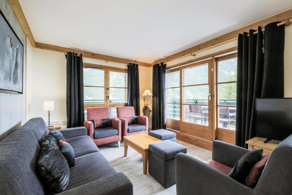 un salon avec un canapé et une télévision dans l'établissement Résidence Les Arcs 1950 Le Village - maeva Home - Appartement 4 pièces 8 personnes - Prestige MAE-2160, à Bourg-Saint-Maurice