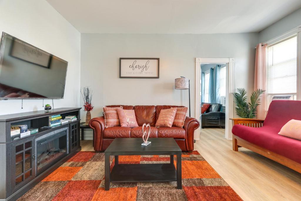 a living room with a couch and a tv at Charming Stoughton Apartment 20 Mi to Boston in Stoughton