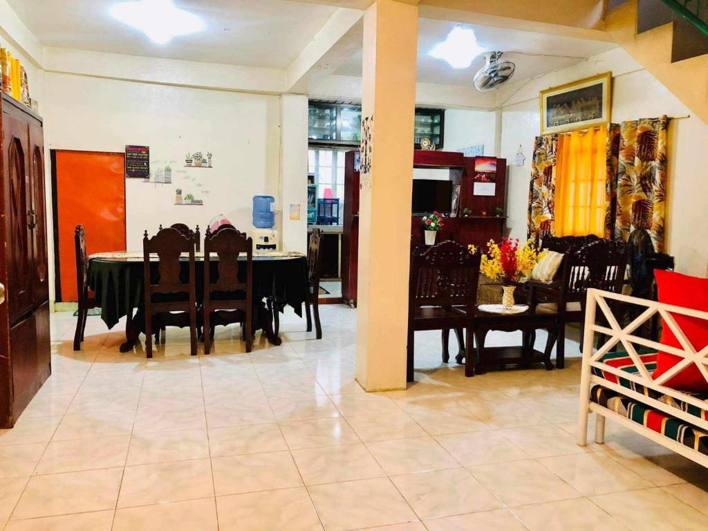 a dining room with a table and chairs at 15pax-U2-Rose&Fer Vigan Transient-Near Calle Crisologo in Bantay