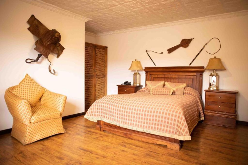 Postel nebo postele na pokoji v ubytování Hosteria Rumipamba De Las Rosas