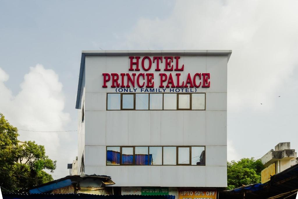 a hotel fence palace sign on the side of a building at Flagship Hotel Prince Palace Near Juhu Beach in Mumbai