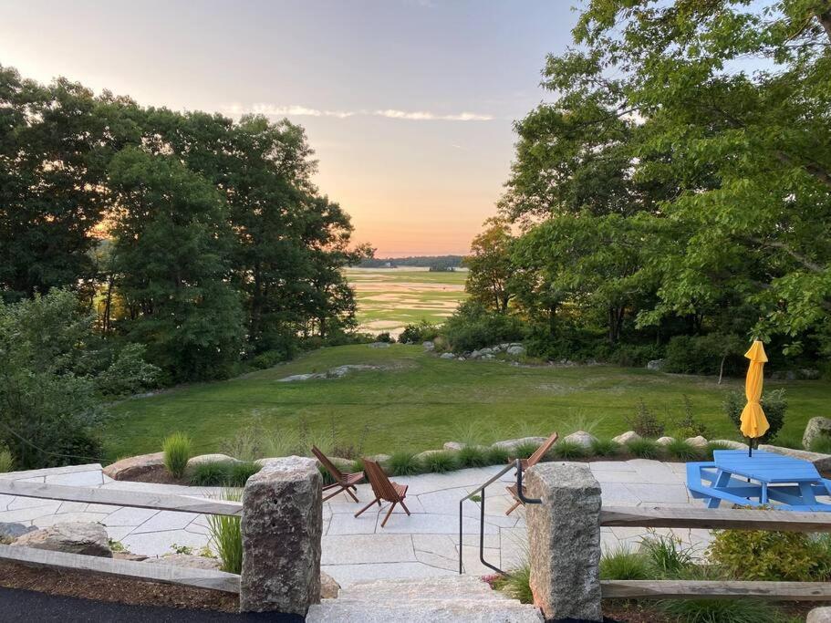 a patio with chairs and a table in a yard at PREMIUM PROPERTY - Private 2-Acre Retreat - MODERN 4 Bedrooms - See Video Tour in Gloucester