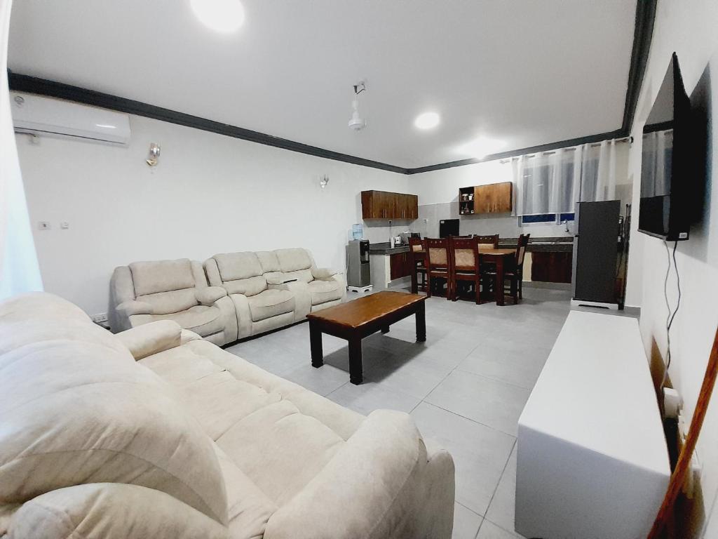 a living room with a couch and a table at Glo stays in Mombasa