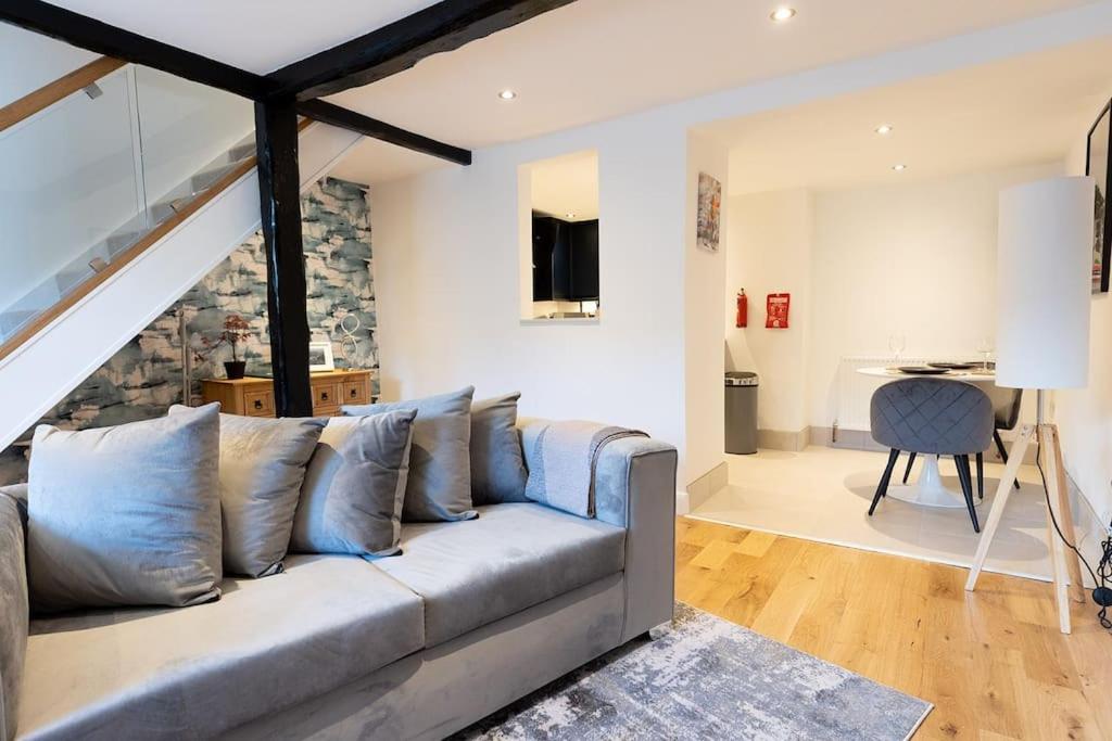 a living room with a couch and a desk at FORD GATE - Modern Luxury Cottage based in Holmfirth in Holmfirth