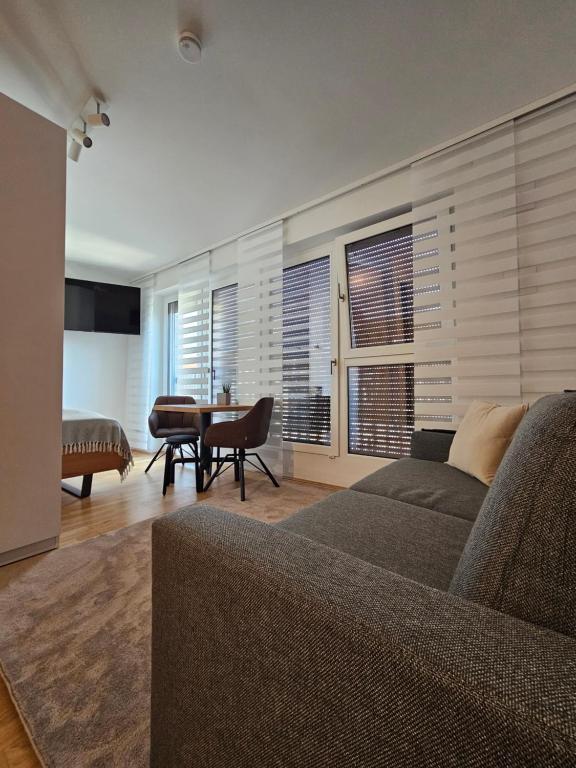 a living room with a couch and a table at HIGH CLASS - Design Apartment - Favorite Place - Full Equipment - Public Transport in Nürnberg