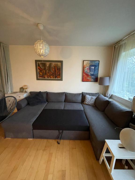 a living room with a large blue couch at Lejlighed med udsigt til Frederiksberg have in Copenhagen