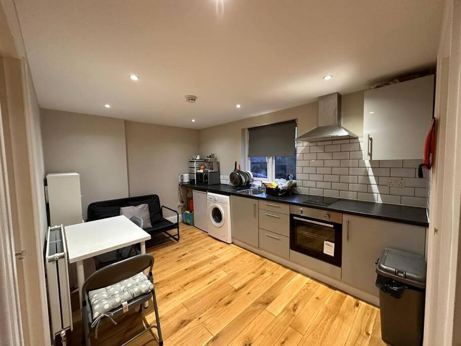 a kitchen with a table and a counter top at Lovely flat in Brockley, SE4 in London