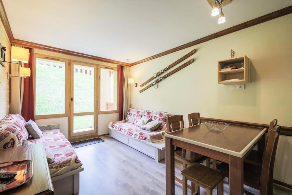 un salon avec une table et un canapé dans l'établissement Résidence La Marelle et Le Rami - maeva Home - Appartement 2 pièces 5 personnes Sélection MAE-9115, à La Plagne Tarentaise