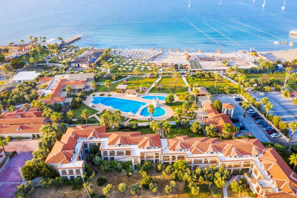 an aerial view of a resort with a pool and the ocean at Alaçatı Beach Resort in Yumru