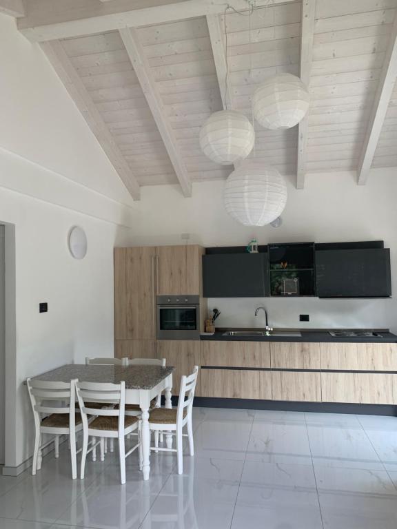 a kitchen with a table and chairs in a room at Oasi verde in Aosta