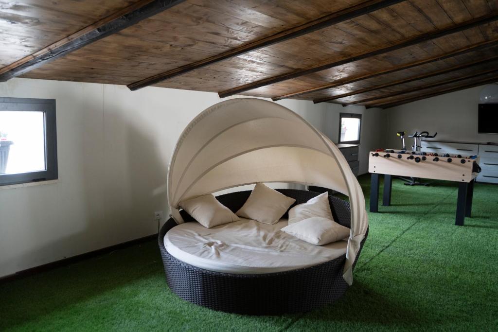 a couch in a room with a ping pong table at Corso Italia Luxury Suite in Fondi