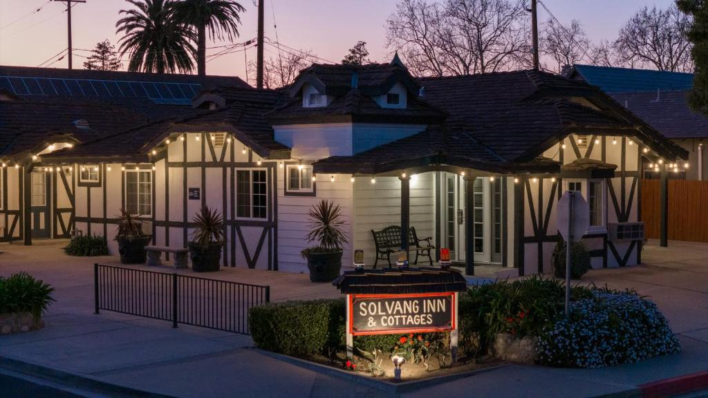 a house with a sell sign in front of it at Solvang Inn & Cottages in Solvang