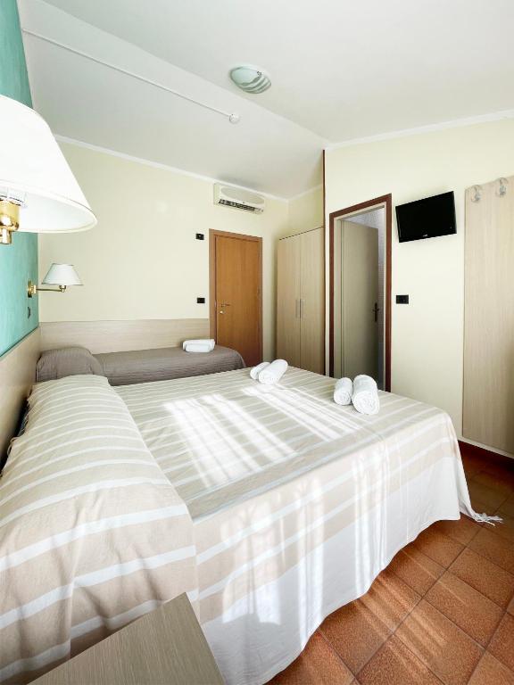 Postel nebo postele na pokoji v ubytování Hotel Reale