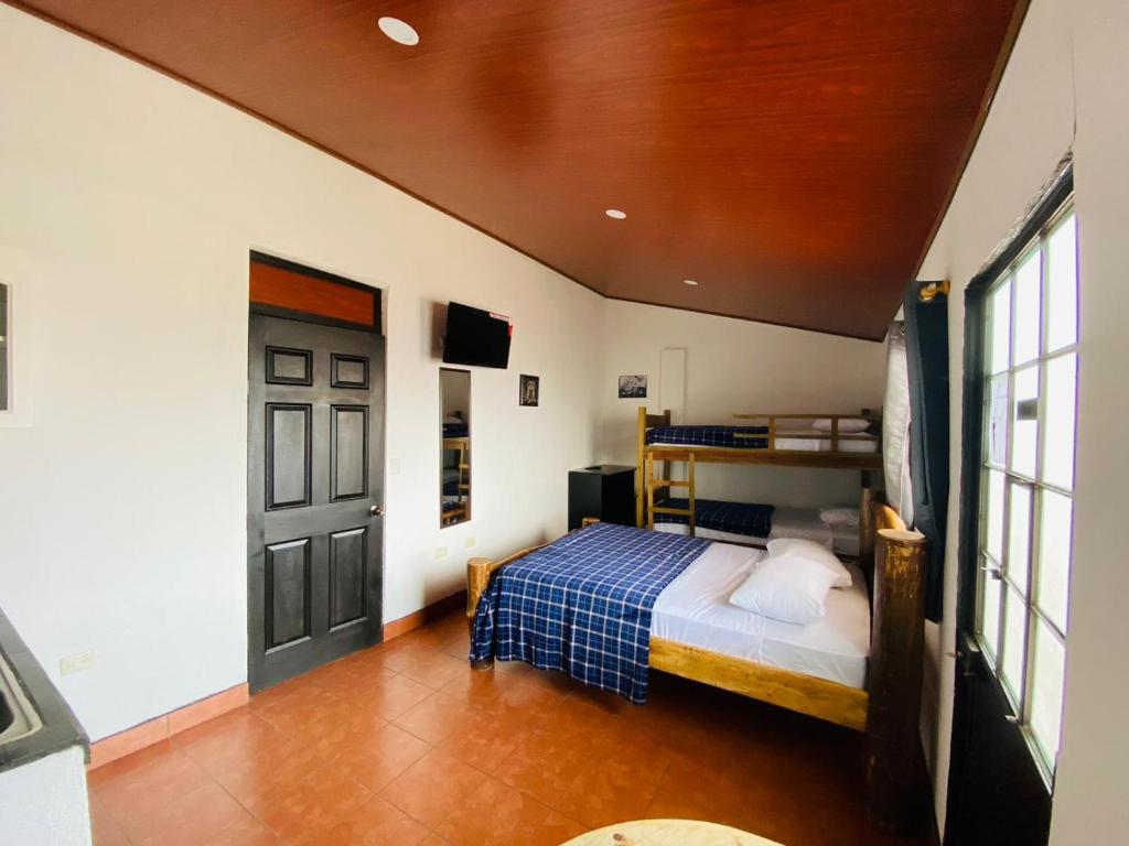 a bedroom with a bed and a black door at Hostal 17-52 in Guatemala