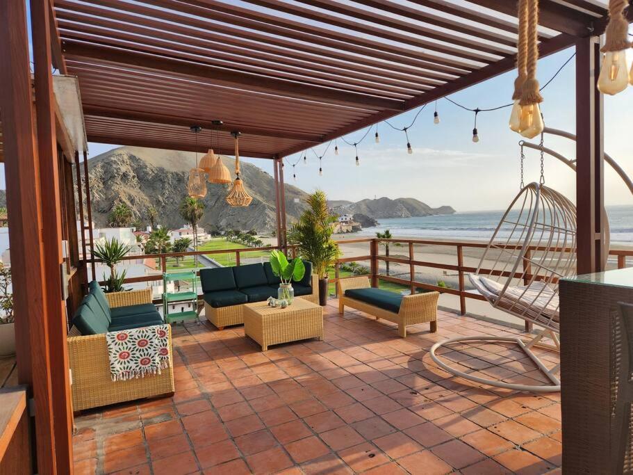 a patio with couches and a view of the ocean at Bujama vista al mar in Asia
