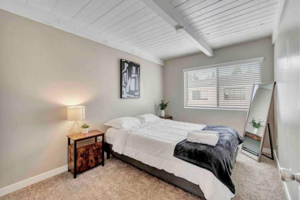 a bedroom with a large bed and a window at North Pomona Home Near Claremont Colleges in Pomona