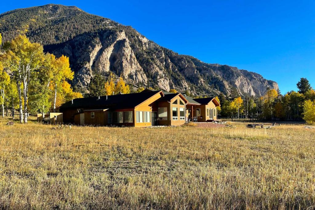 a house in a field in front of a mountain at Colorado Mountain Getaway about 12 Mi to Buena Vista! in Nathrop