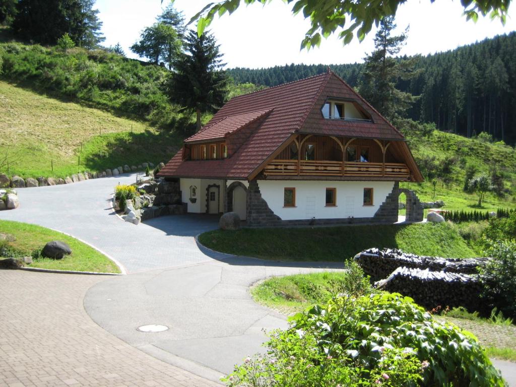 a house on the side of a mountain at Holzbildhauerei Kammerer in Triberg