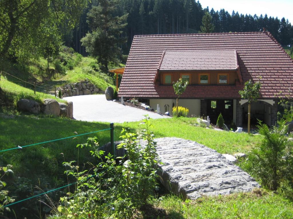 a house on a hill with a stone path at Holzbildhauerei Kammerer in Triberg