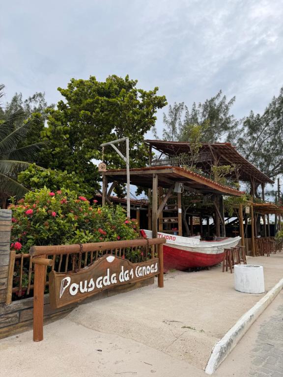a restaurant with a boat on the beach at Pousada das Canoas in Acaraú