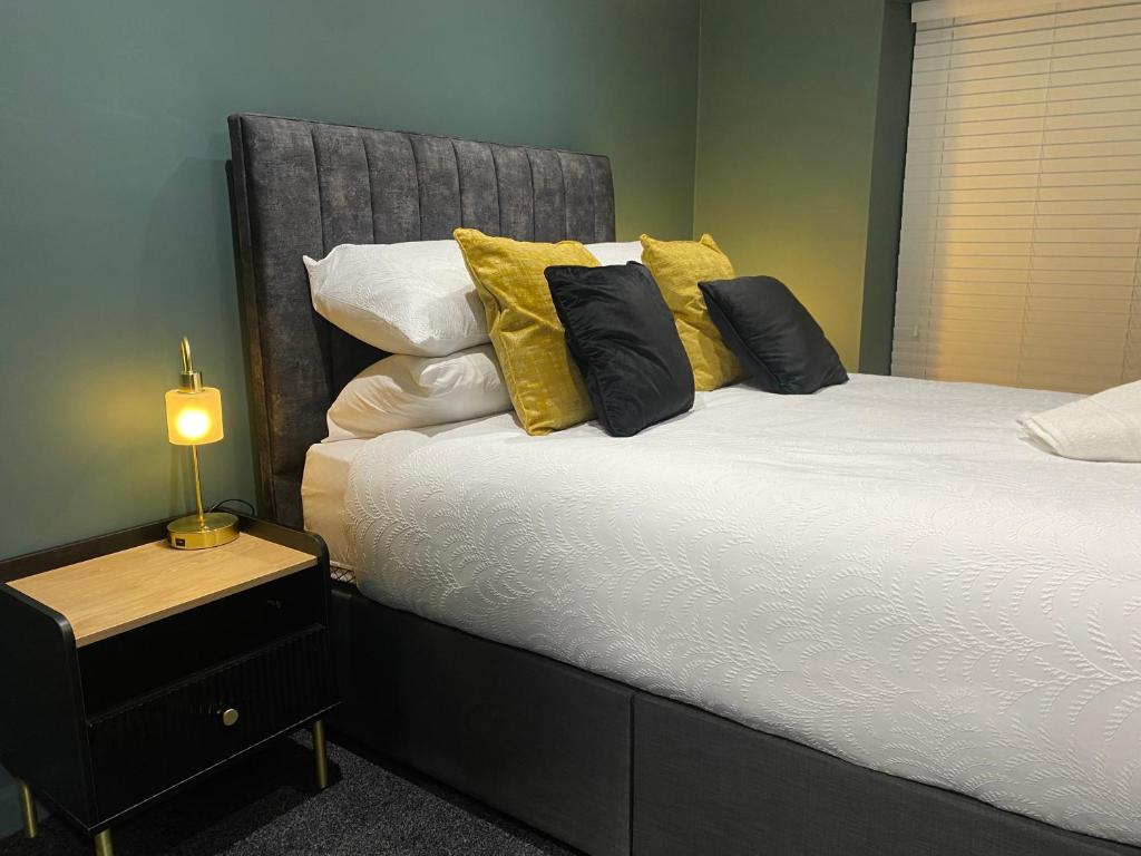 um quarto com uma cama grande e almofadas amarelas em The Butchers Arms - Grill Pub and Accommodation em Merthyr Tydfil