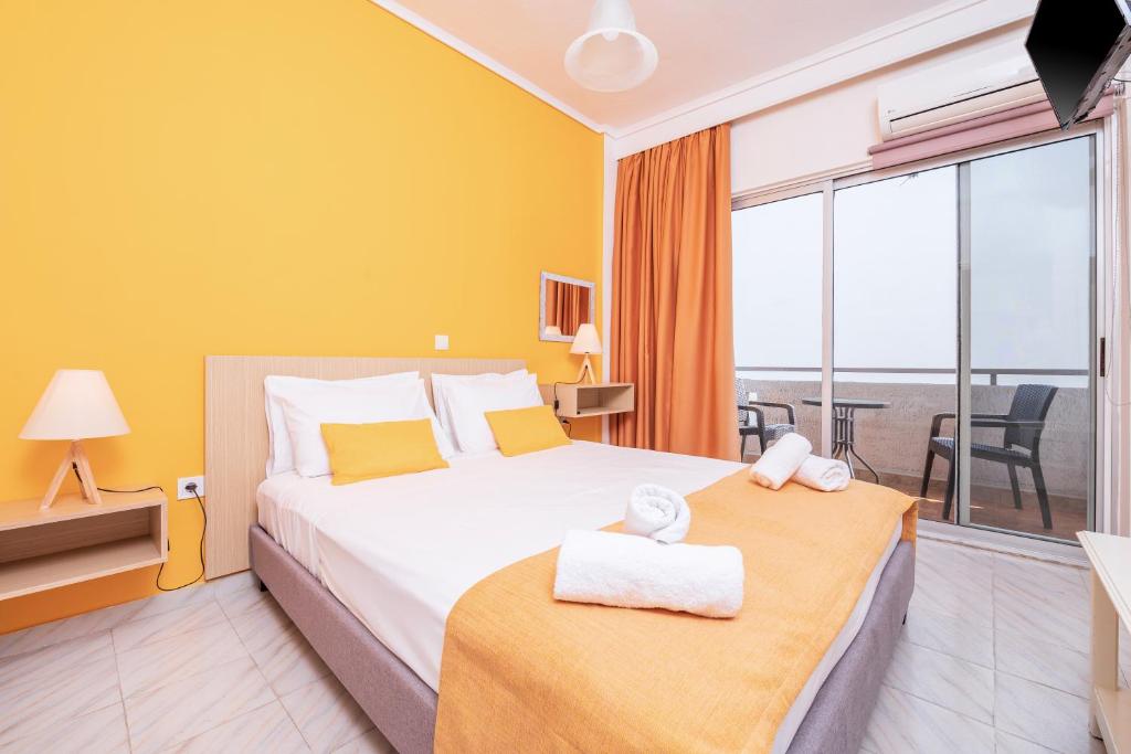 a hotel room with a bed and a balcony at City Life Marina apartment No. 2 in Ampavris